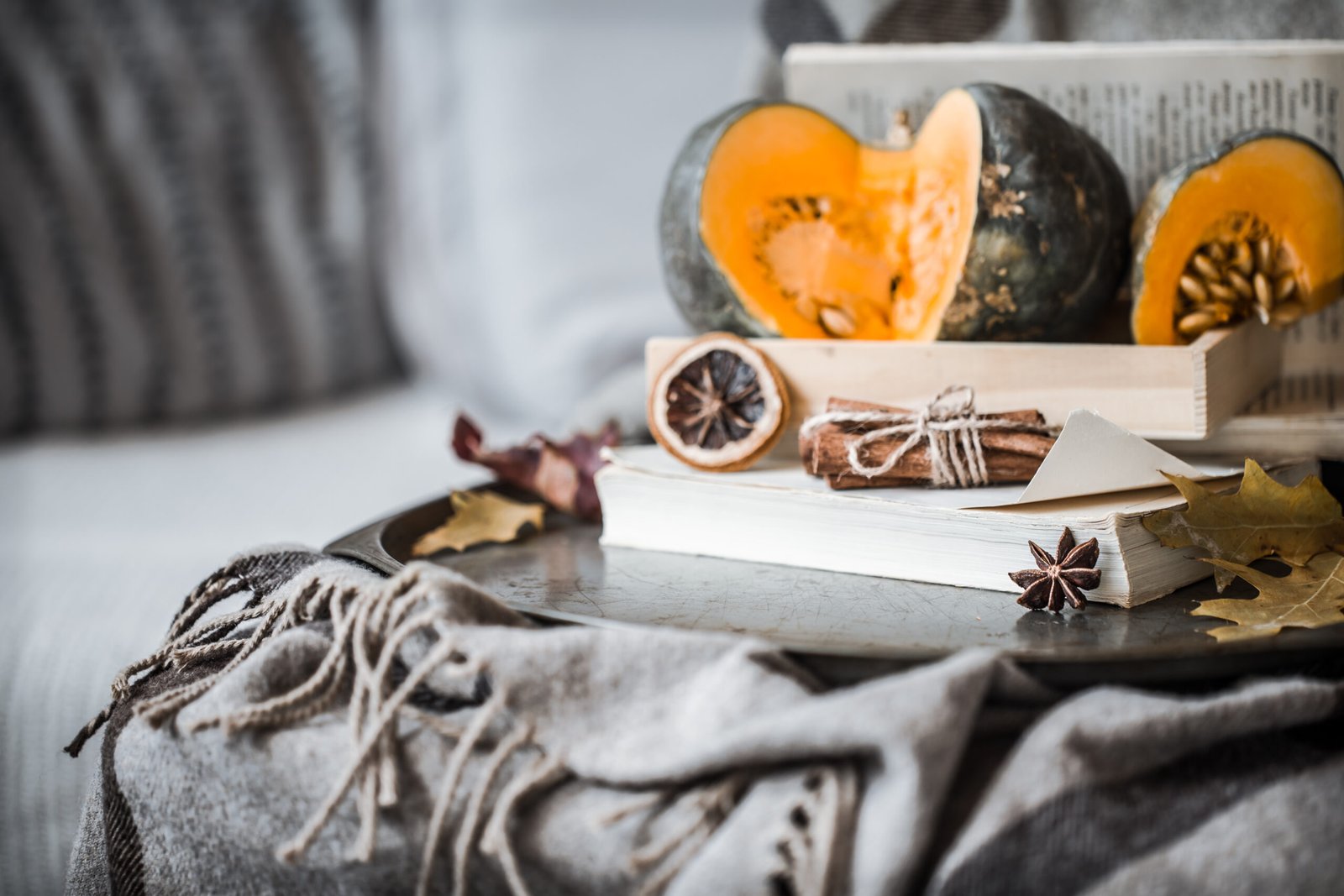 Cozy autumn still life details in the living room. Autumn composition with Cup and pumpkins , the concept of leisure and autumn weekends